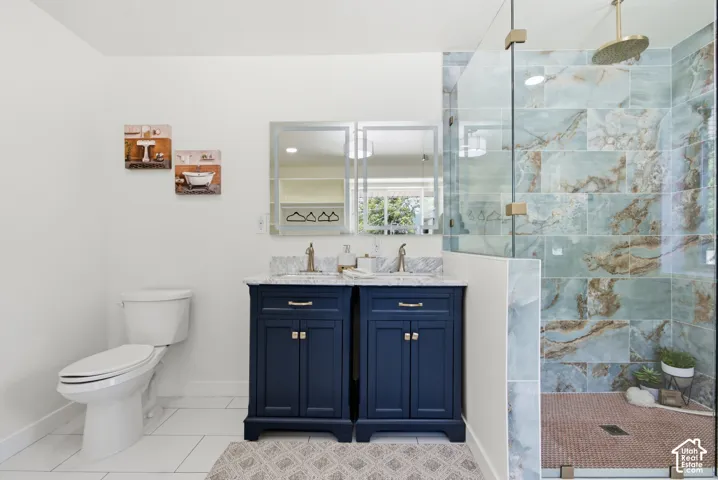 Dual navy vanity with stone countertops and brushed nickel fixtures