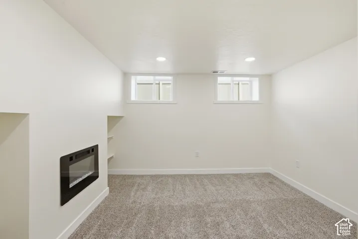 Recessed wall-mounted fireplace with a black surround