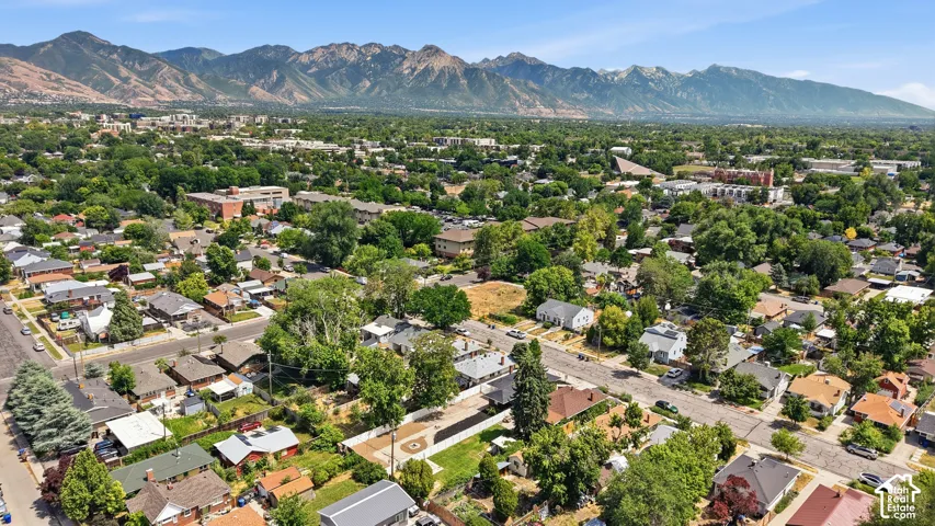 Expansive residential area featuring a variety of homes, mature trees, and mountainous topography