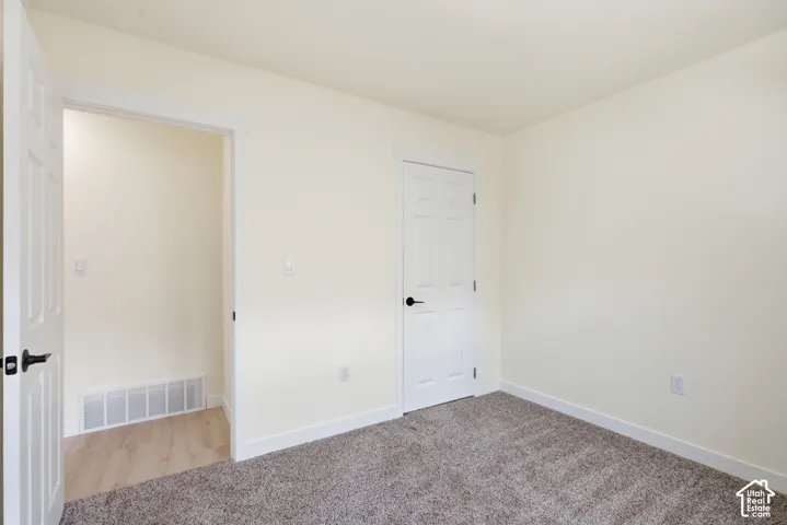 Neutral-toned interior featuring plush carpeting and light-colored walls