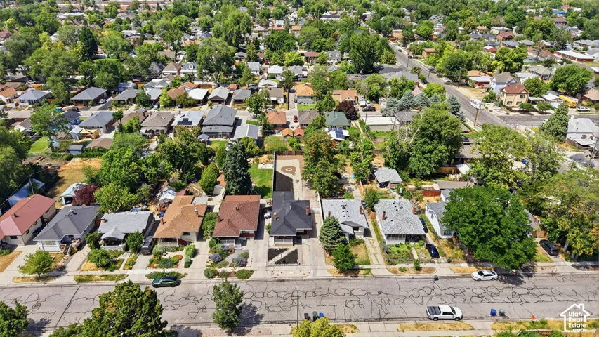 Aerial perspective showcasing a residential neighborhood with mature tree coverage