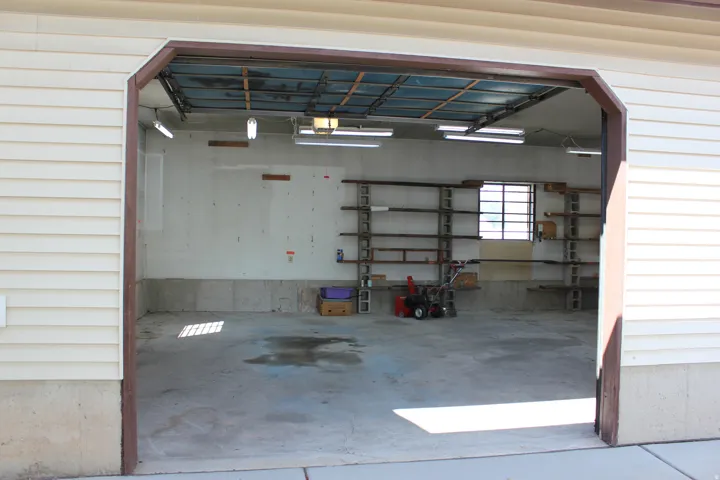 Garage interior featuring concrete flooring and a grid window