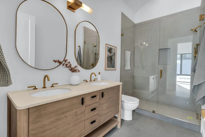 Dual vanity with wood-finish cabinetry and undermount sinks