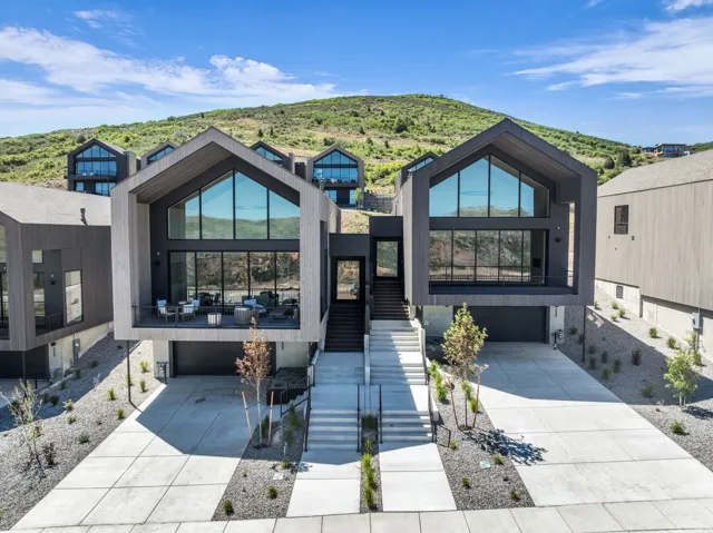 Contemporary architecture featuring a steeply pitched roofline and expansive floor-to-ceiling windows