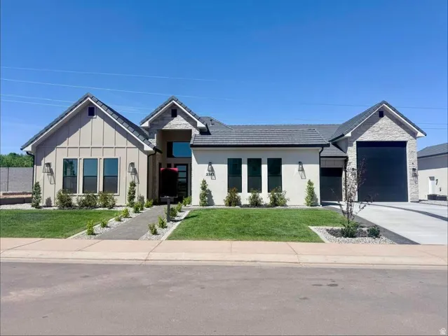 Modern exterior featuring a combination of stucco, vertical siding, and stone accents