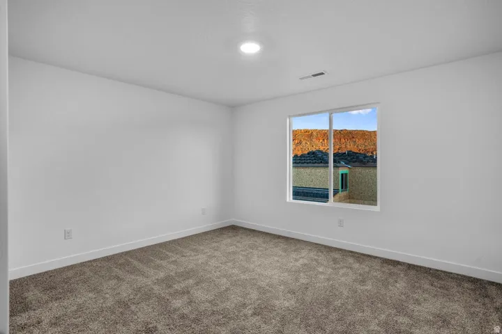 Carpeted room featuring a single window and recessed ceiling lighting