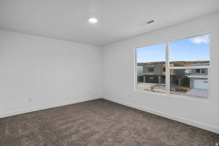 Spacious room featuring neutral paint, recessed lighting, baseboard trim, and plush carpeting