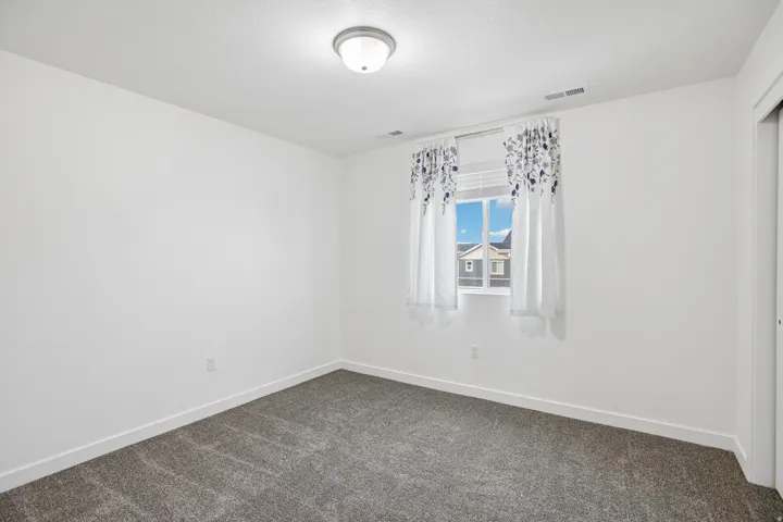 Neutral wall finishes with a window offering natural illumination