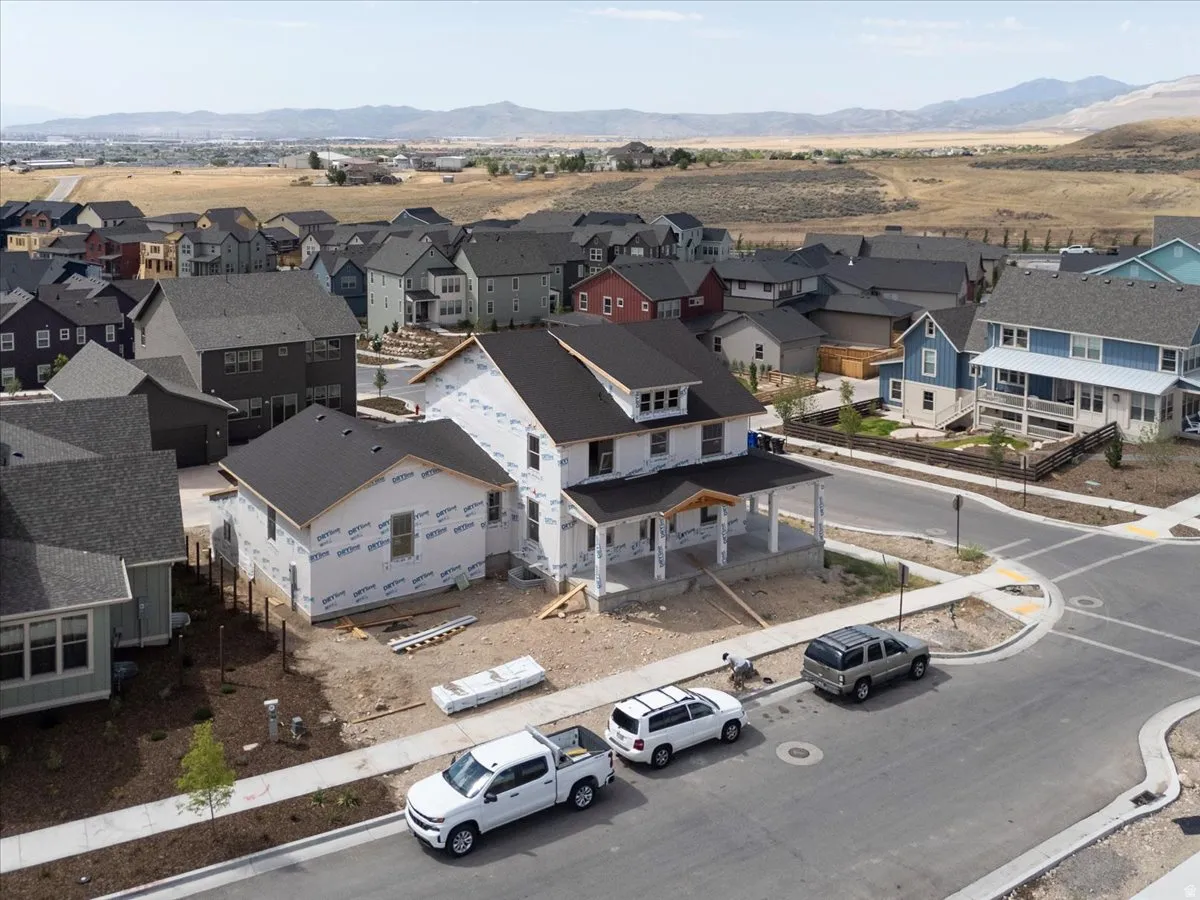 Newly constructed residential property featuring a large front porch and a prominent corner lot location
