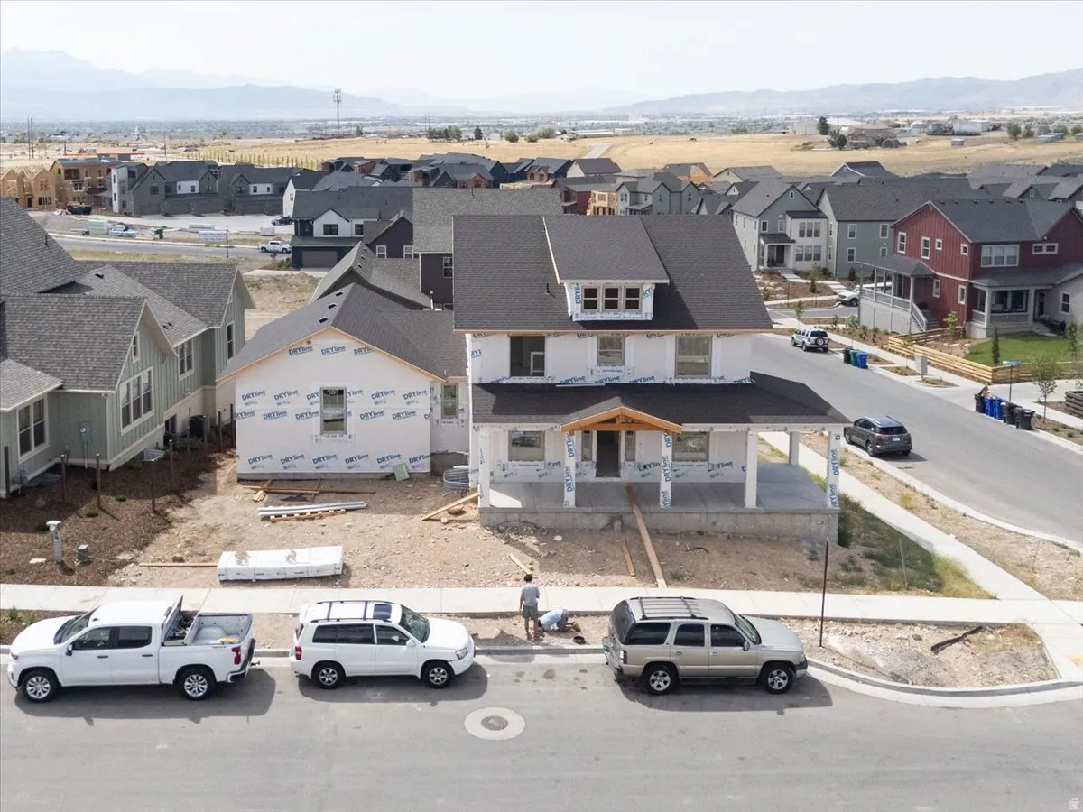 Developing two-story residence featuring a covered front porch and dormer window