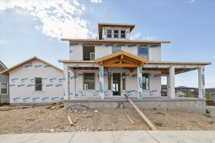 New construction with a prominent two-story main structure and an attached single-story extension