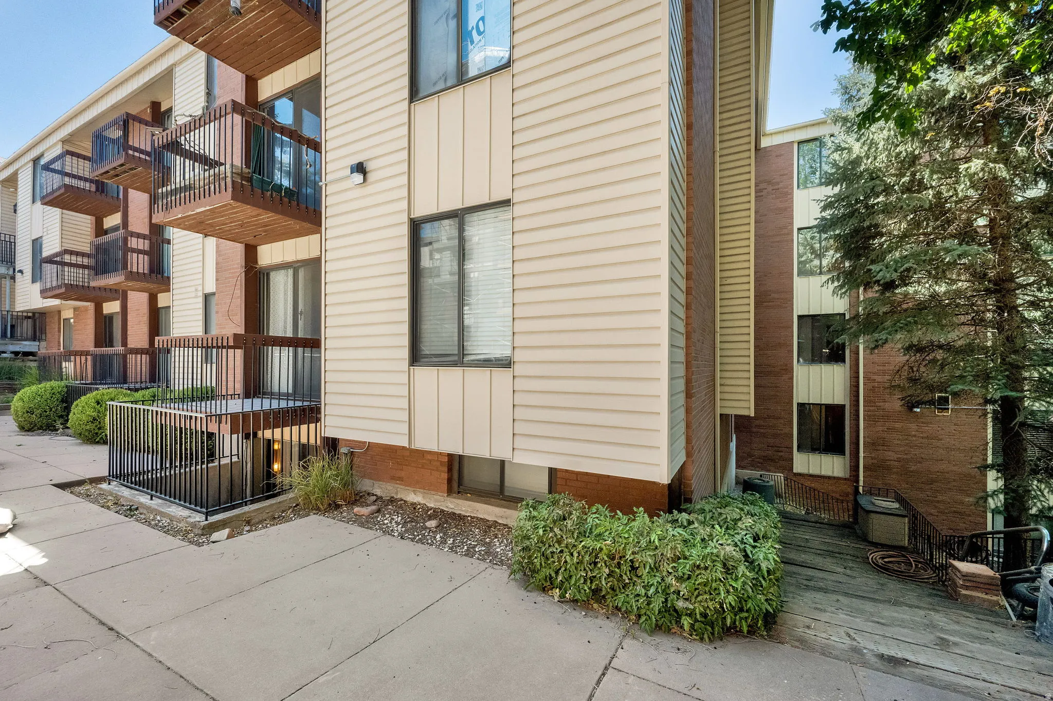 Multi-story building exterior featuring vertical siding and brickwork