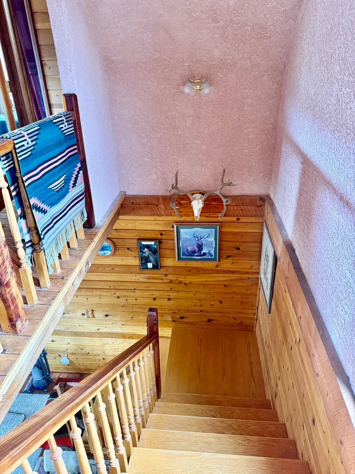 Natural wood-finish staircase with matching balusters and handrail