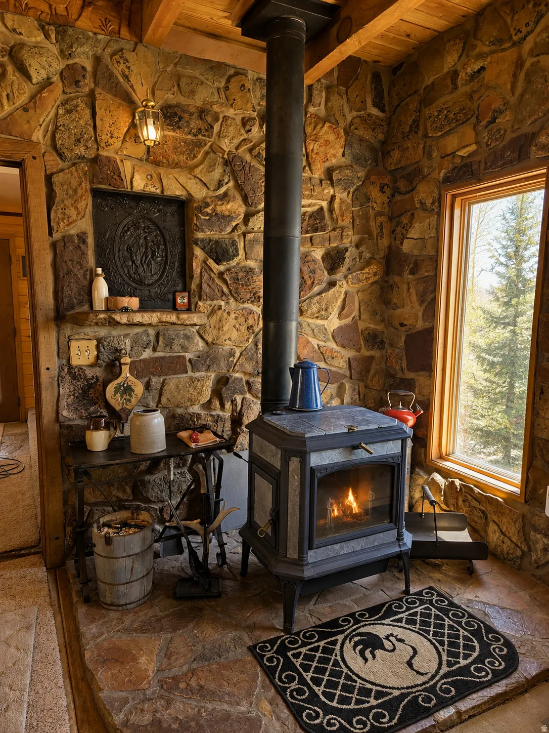 Stone accent wall with a built-in wood stove and exposed wood beam ceiling
