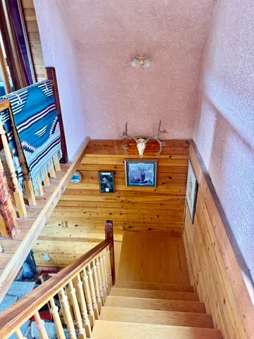 Natural wood-finish staircase with matching balusters and handrail