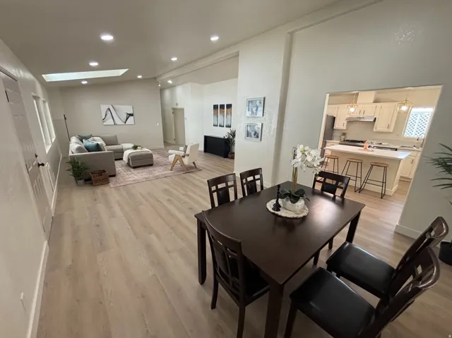 Open-concept living area featuring light wood-finish flooring throughout