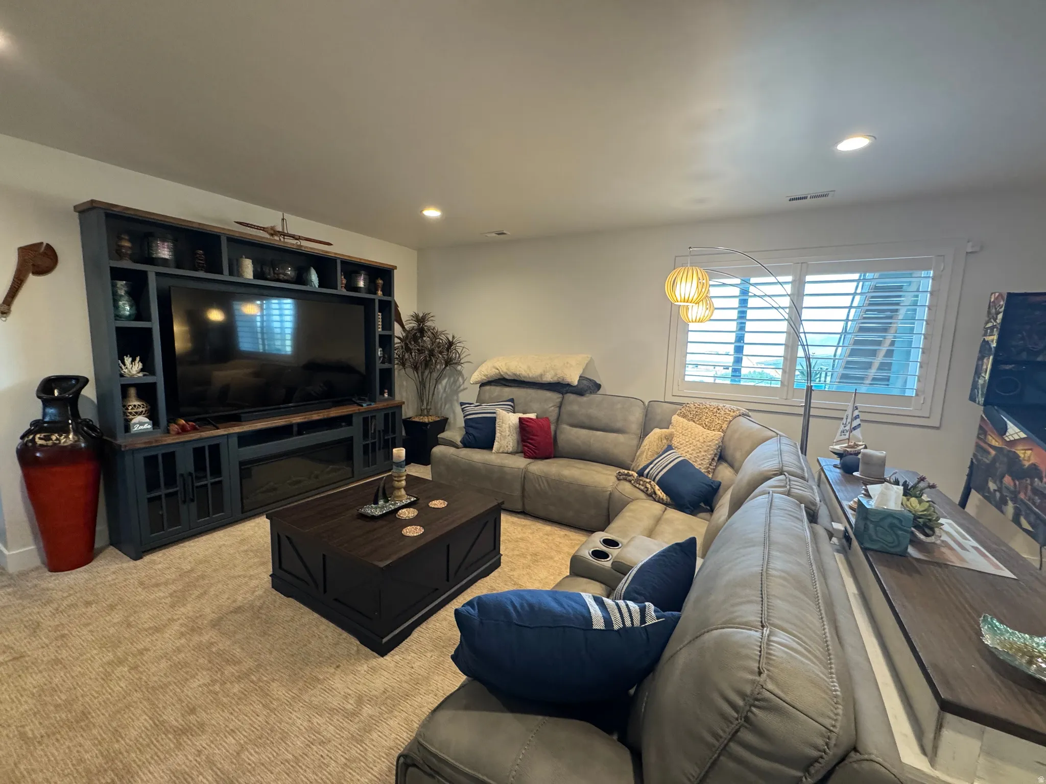 Built-in media console with integrated electric fireplace and display shelving