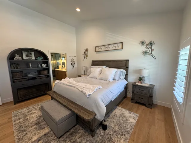 Spacious interior featuring wood-finish flooring, high ceilings with recessed lighting, and an arch-top built-in display cabinet with an integrated fireplace