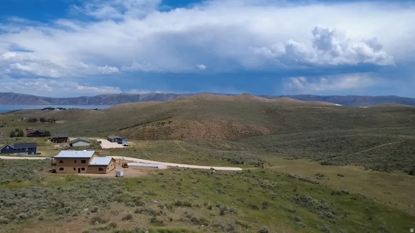 Expansive undeveloped land featuring rolling hills, varied topography, and distant water views