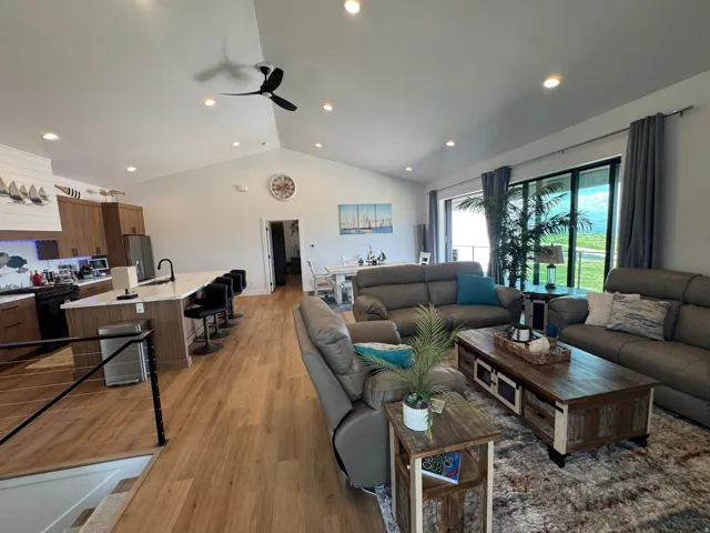 Open-concept living space featuring vaulted ceilings and recessed lighting