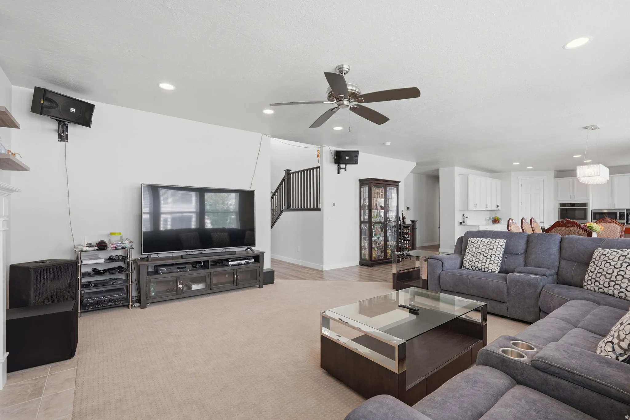 Spacious living area featuring recessed lighting, a ceiling fan, and carpeted flooring