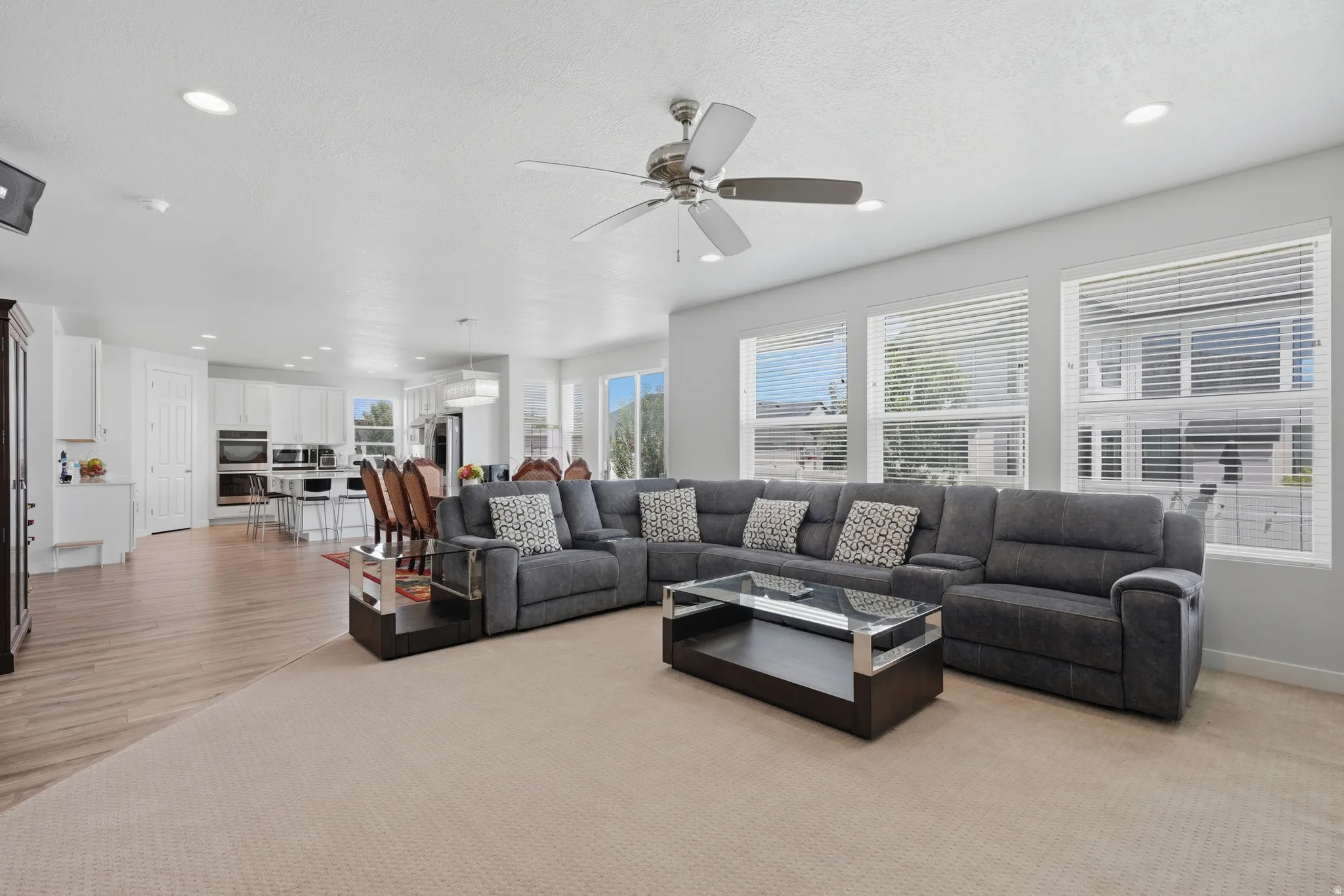 Open concept living area with recessed lighting and a ceiling fan