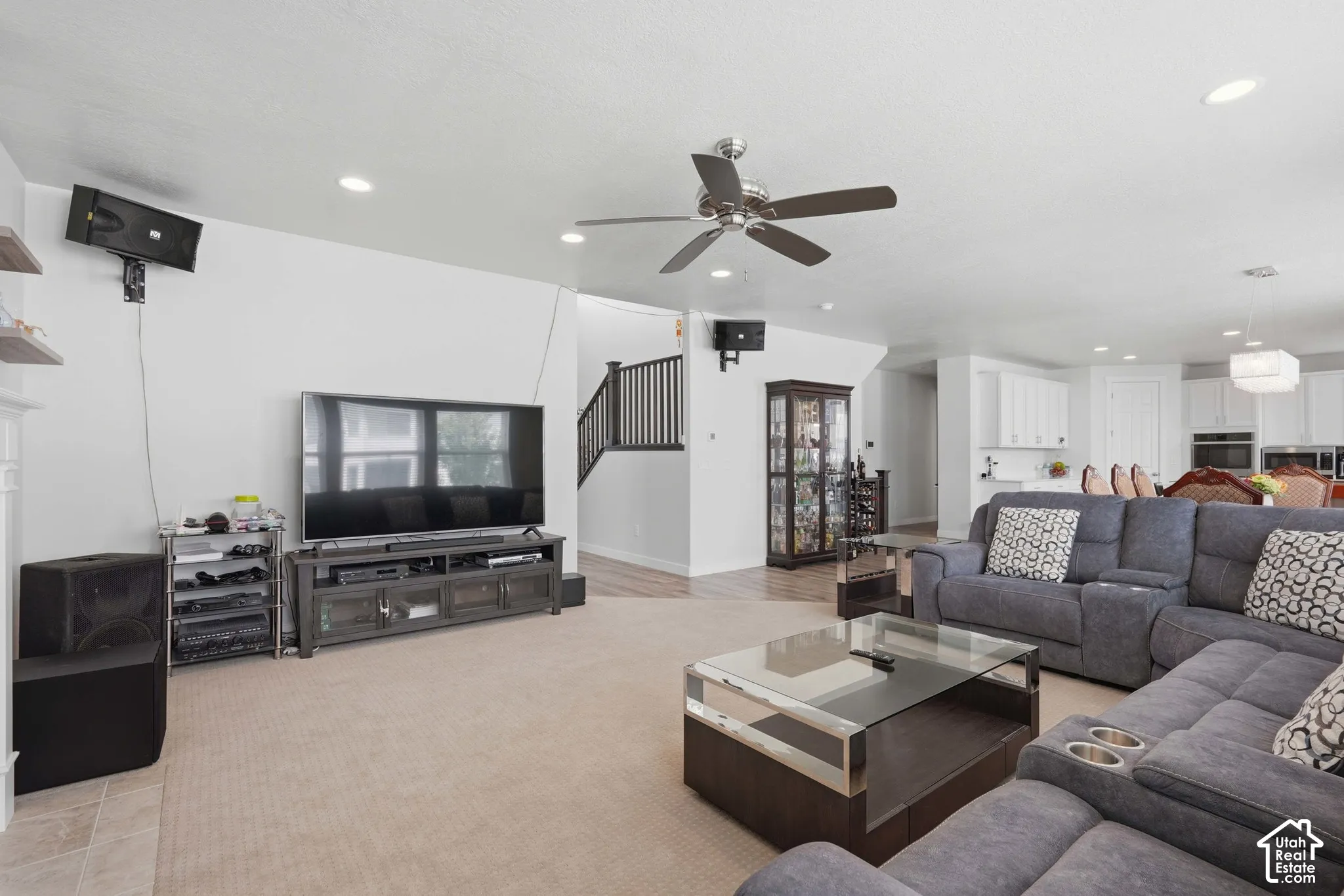 Spacious living area featuring recessed lighting, a ceiling fan, and carpeted flooring