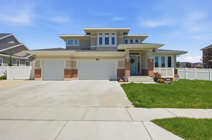 Contemporary exterior featuring stucco siding and brick accents