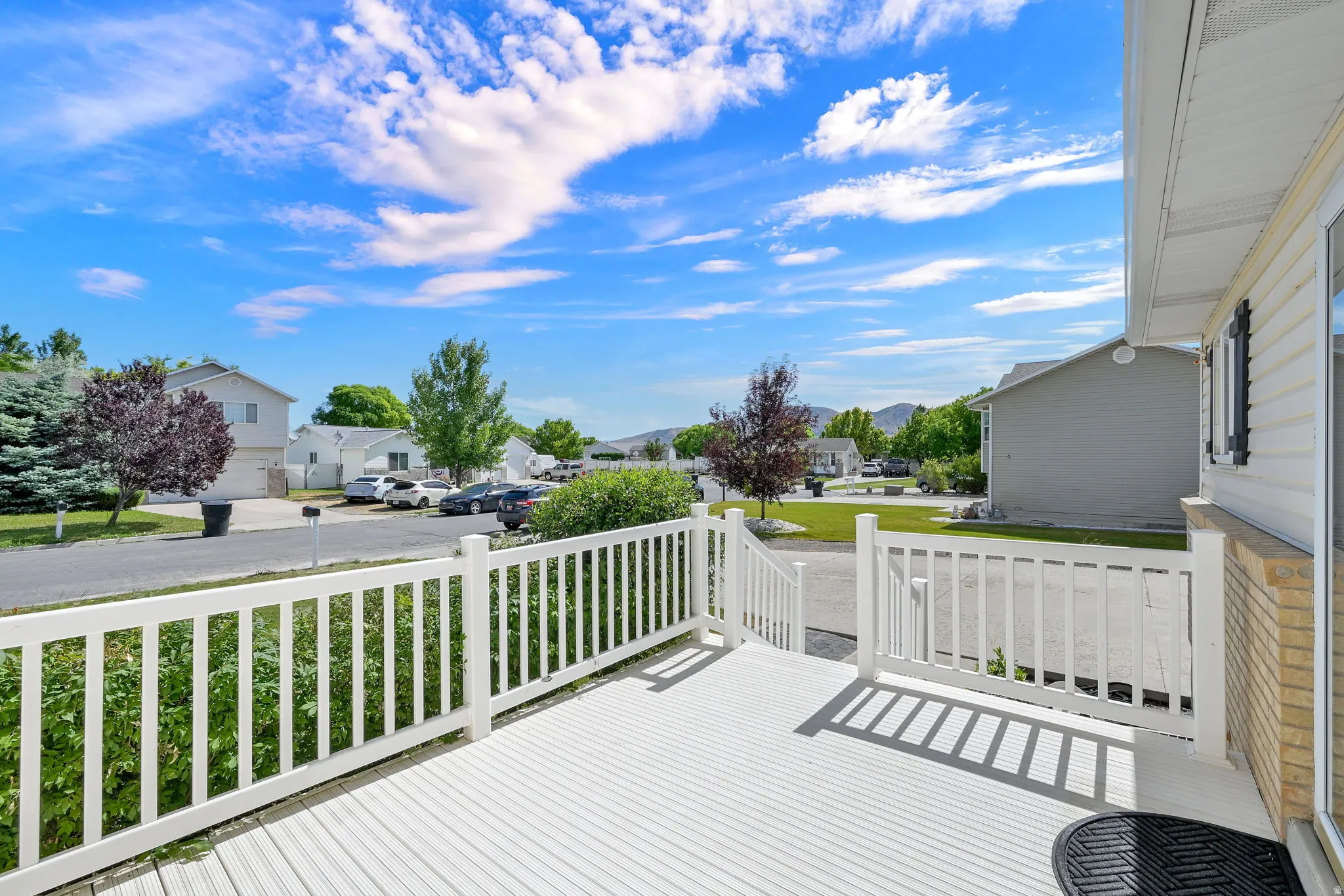 White deck with matching railing, offering exterior space