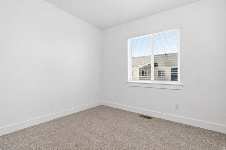 Bright room with a large window and white blinds