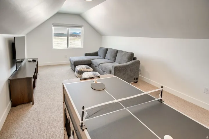 Attic bonus room featuring sloped ceilings, recessed lighting, and light-colored carpeting