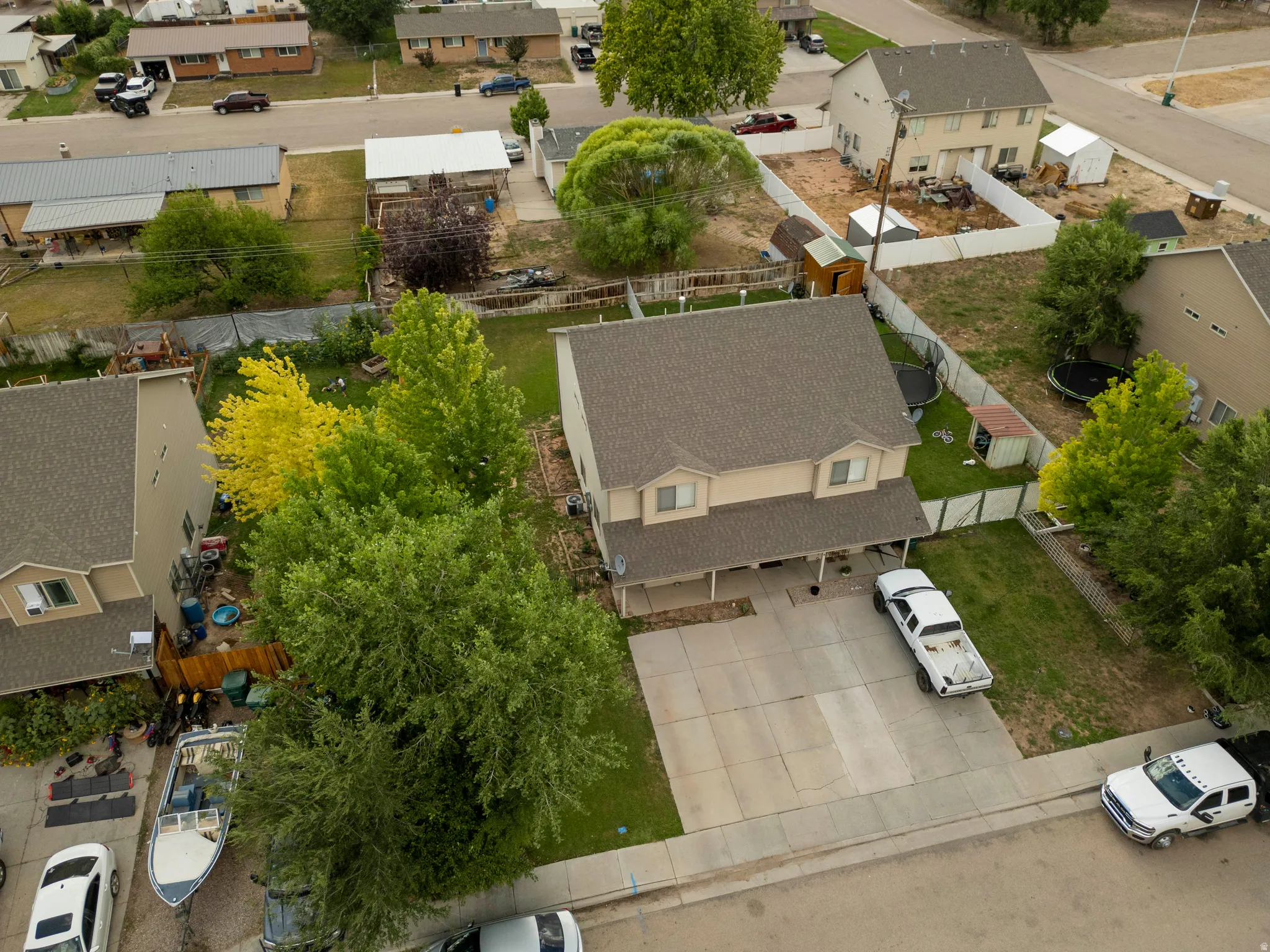 Two-story home featuring a two-car concrete driveway and a covered front porch