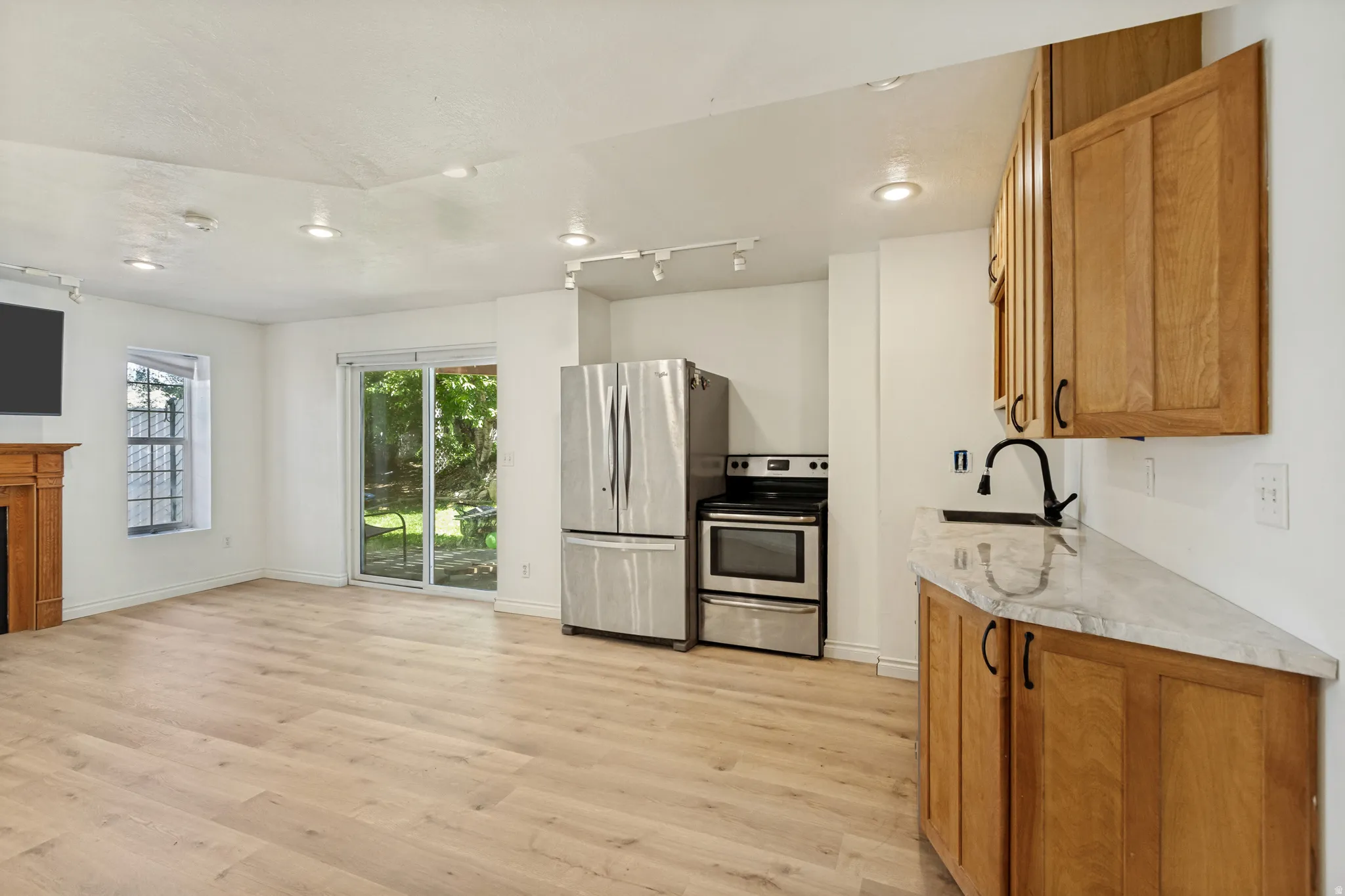 Open-concept living space with light wood-finish flooring