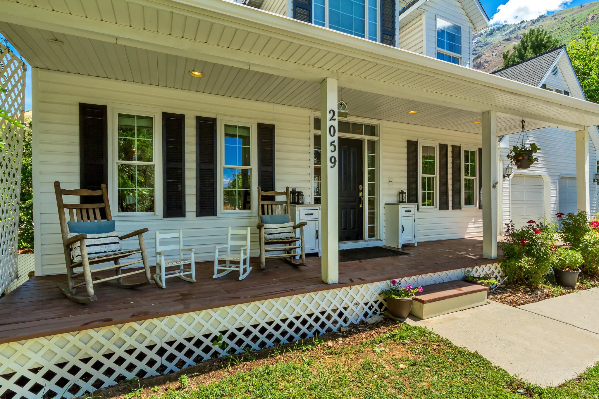 Covered front porch with white siding exterior