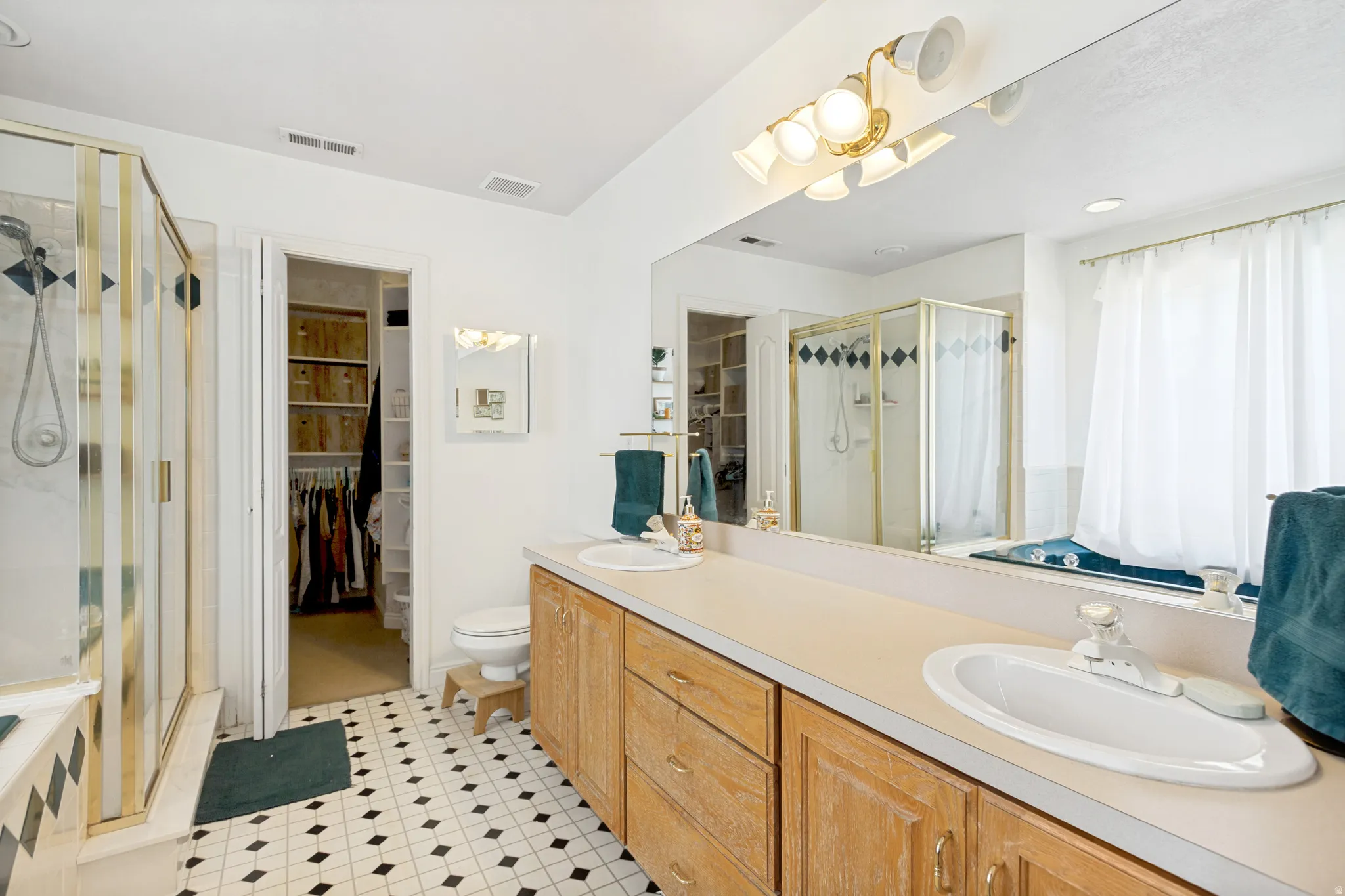 Double vanity with integrated sinks and wood-finish cabinetry