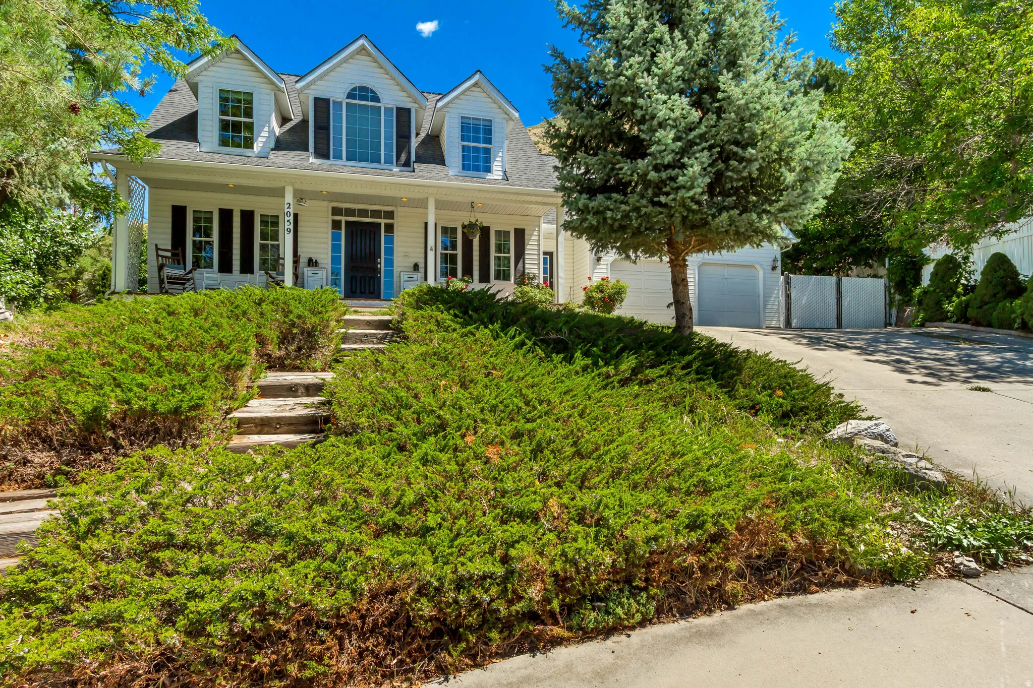 Traditional two-story residence with a covered front porch and dormer windows