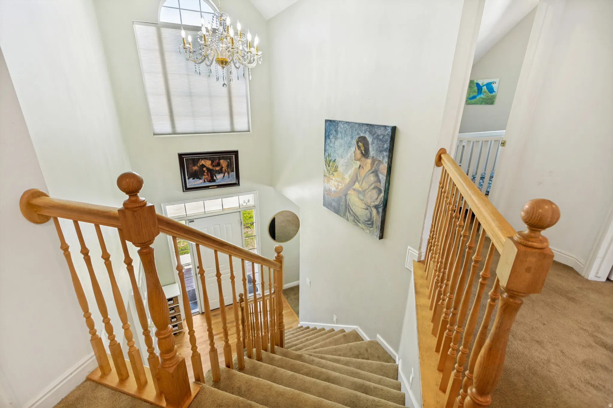 Two-story foyer with a grand chandelier and arched window