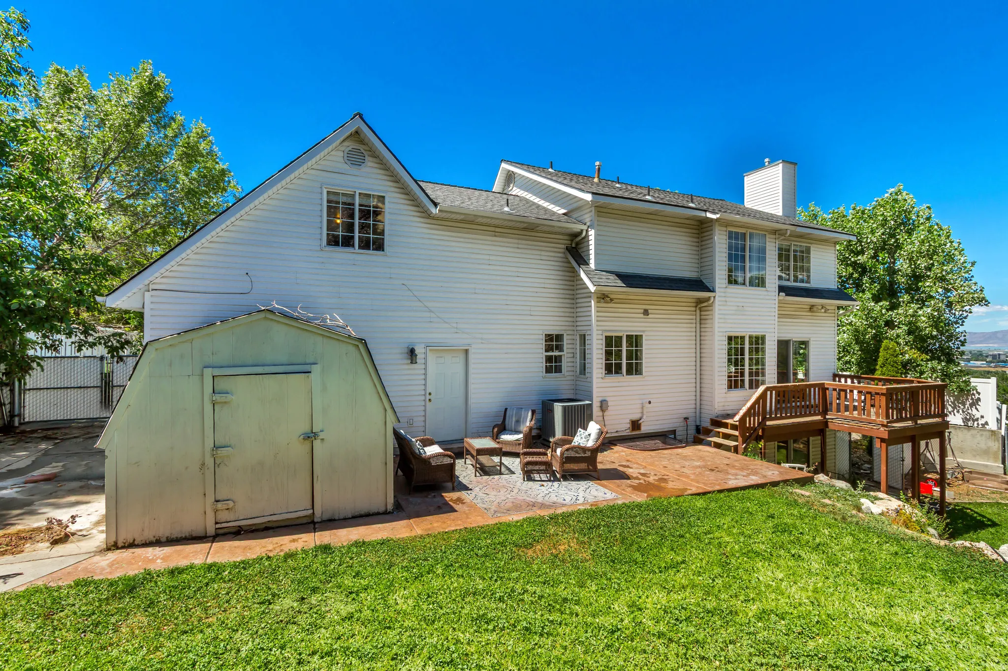 Rear exterior featuring white siding and multiple windows