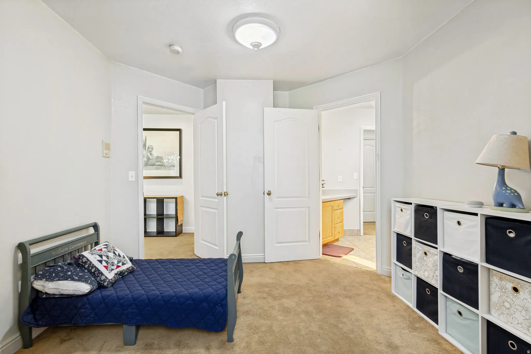 Neutral wall finishes complement the textured carpet