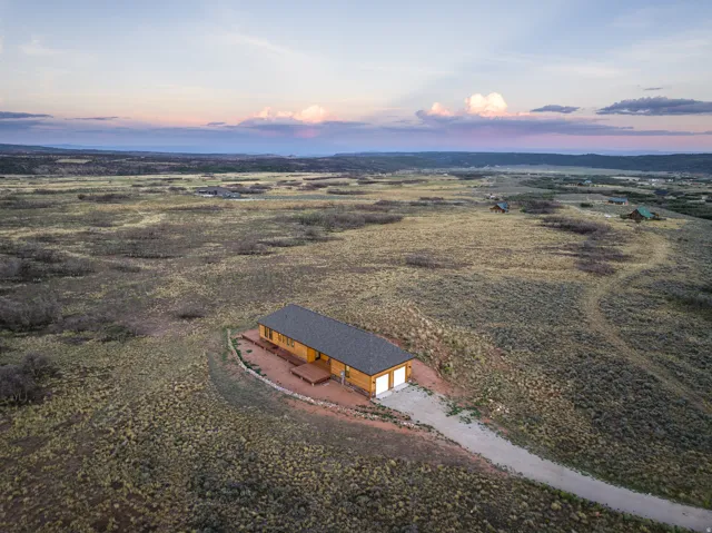Single-story cabin-style residence with a dark shingled roof
