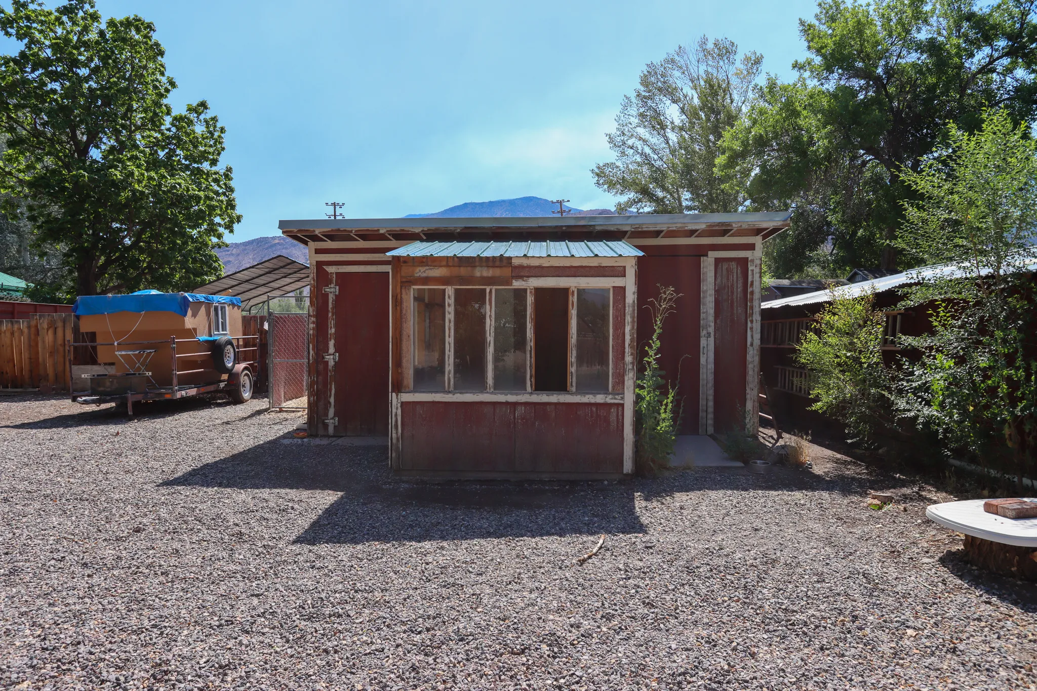 Freestanding shed with a red-painted exterior and a multi-pane window