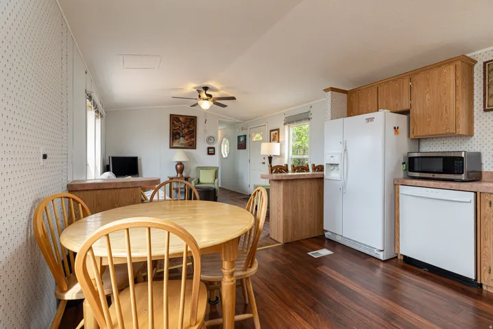 Open-concept living area featuring rich wood-finish flooring