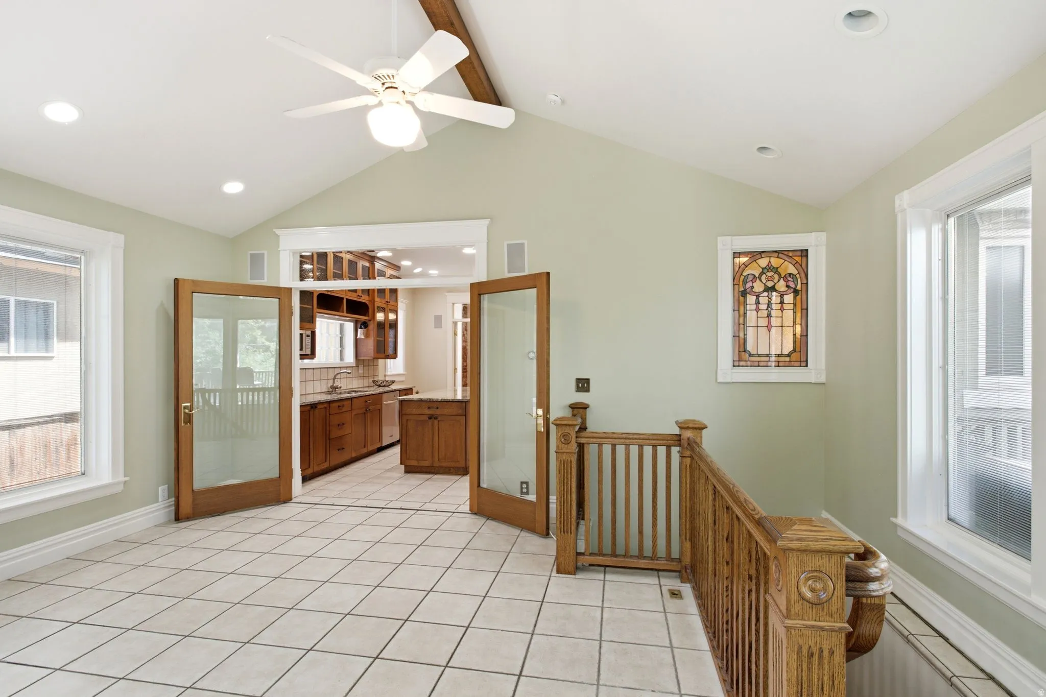 Vaulted ceiling with exposed wood beam and ceiling fan