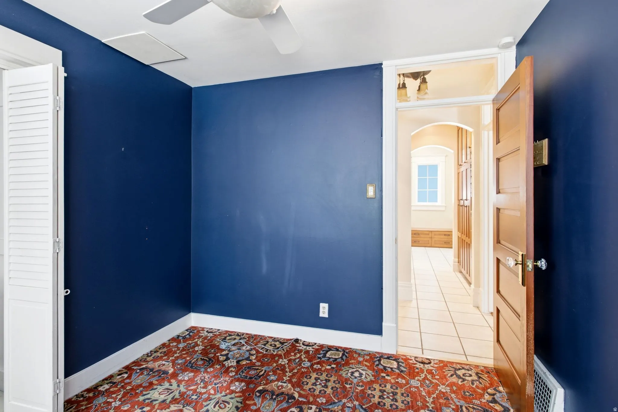 Interior room featuring deep blue walls and a patterned area rug