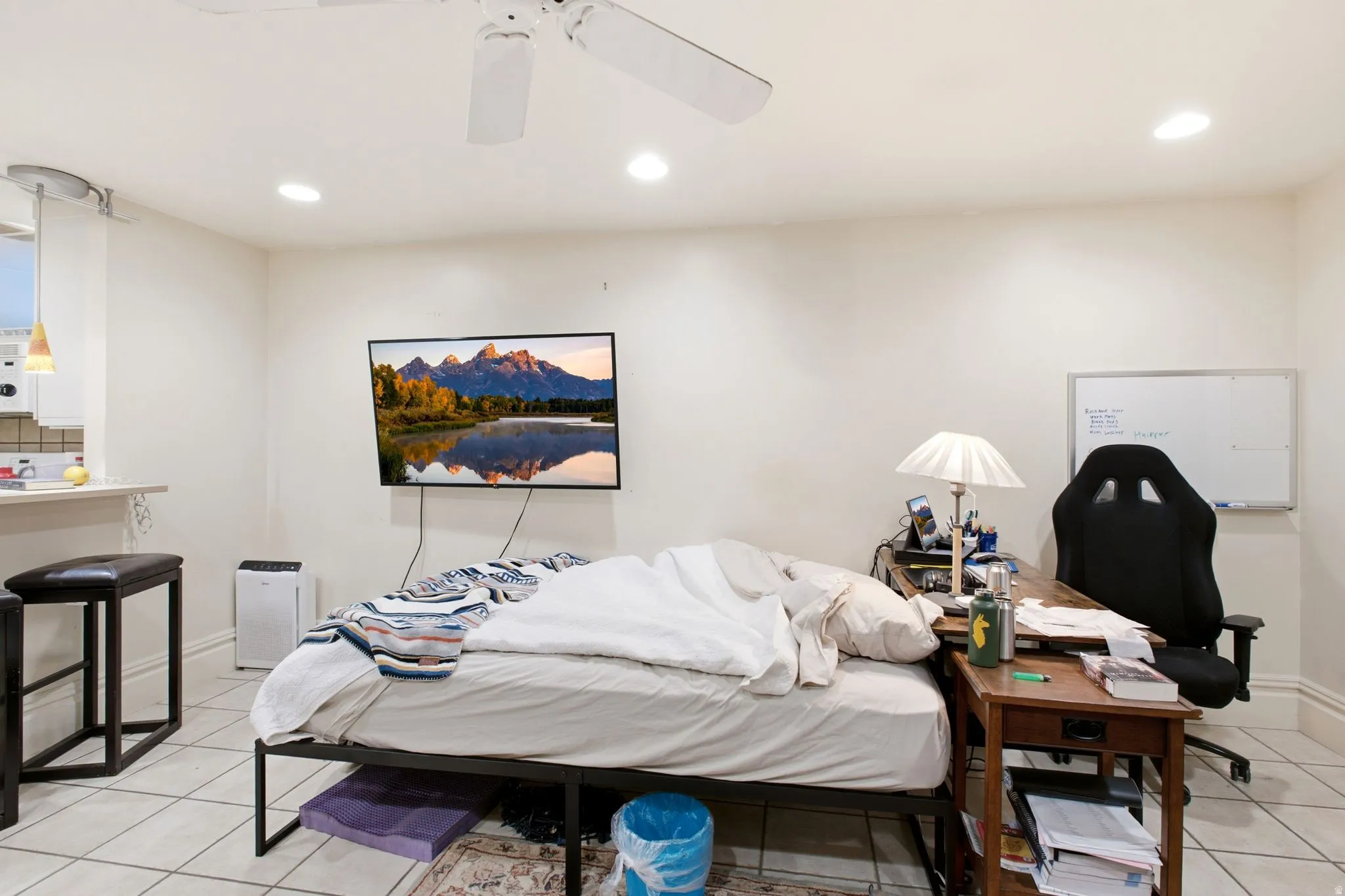 Open-concept space featuring tile flooring and recessed lighting