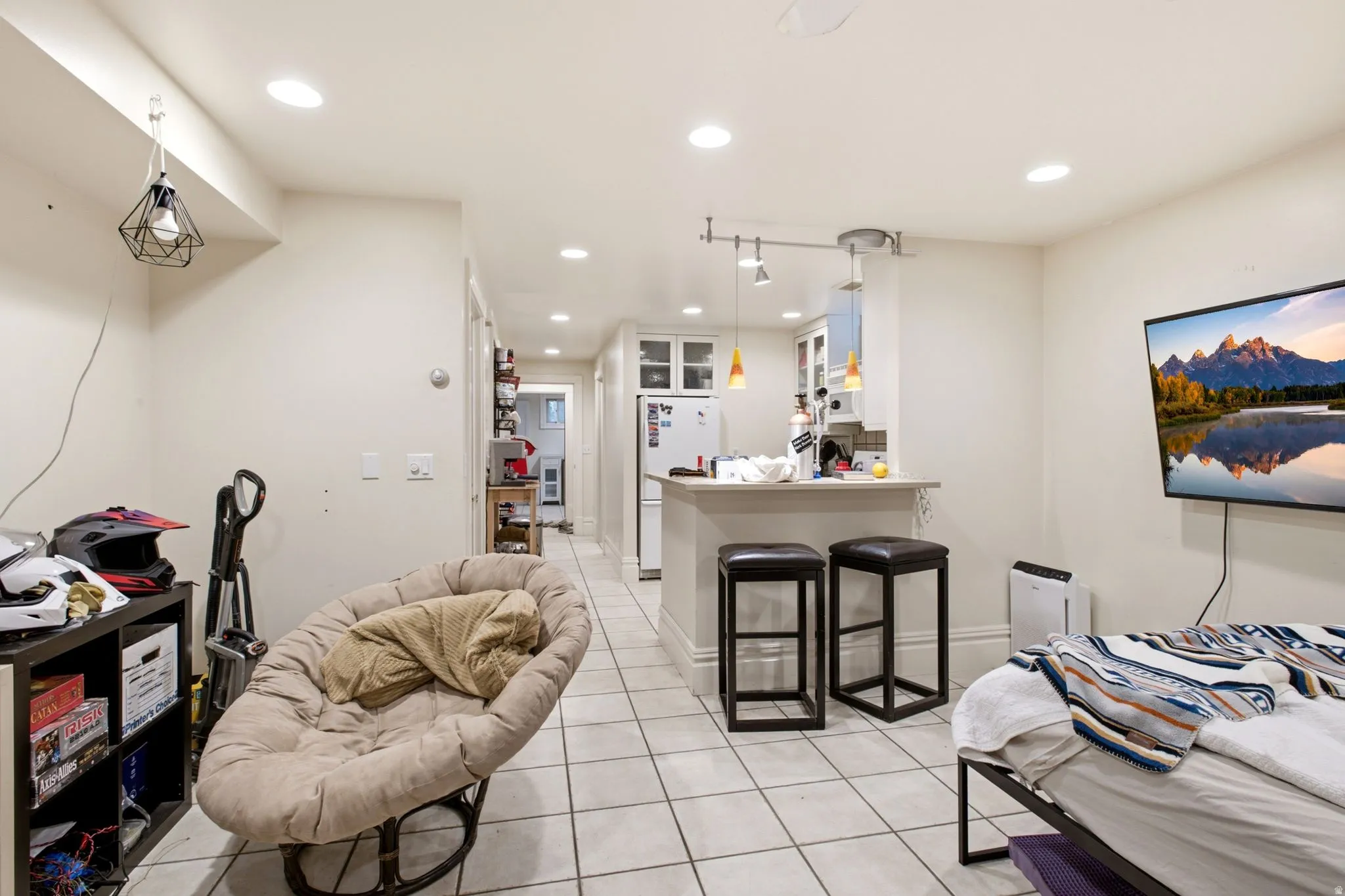 Open-concept living area with tile flooring and recessed lighting