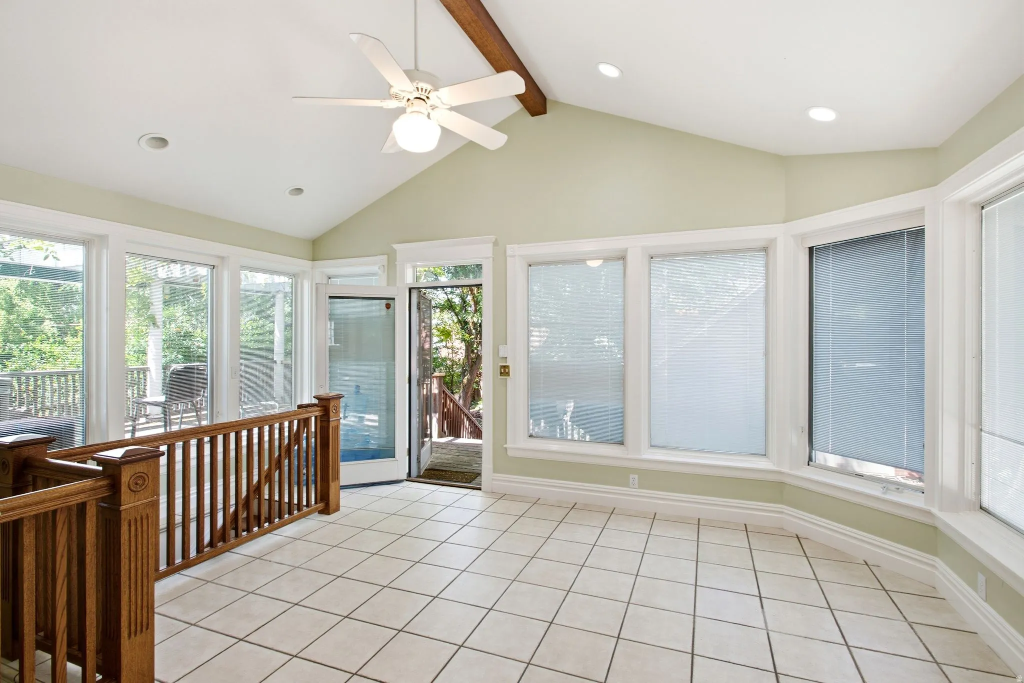 Room featuring a vaulted ceiling with exposed beam, ceiling fan, and recessed lighting