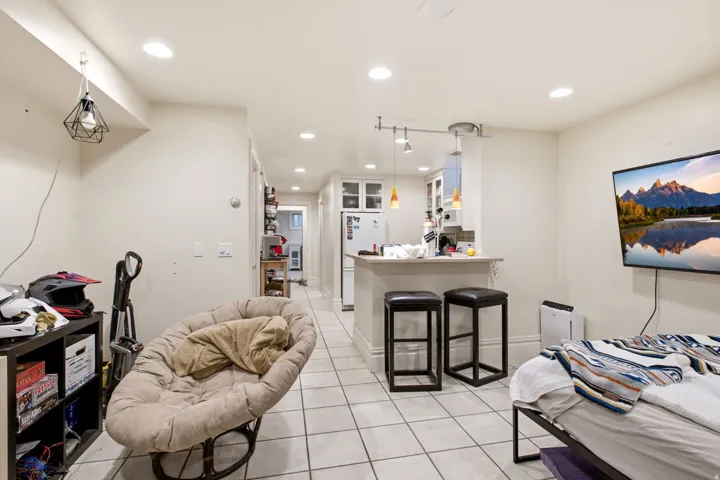 Open-concept living area with tile flooring and recessed lighting