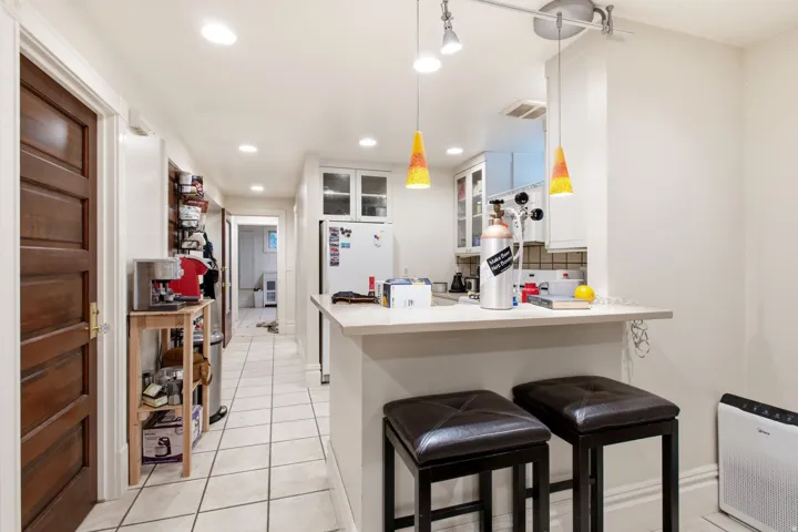 Kitchen area featuring an eat-in counter with pendant lighting