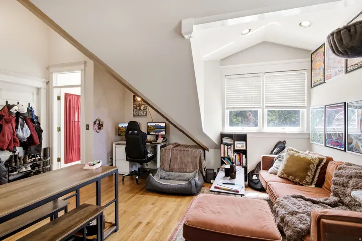 Hardwood flooring throughout featuring a vaulted ceiling and recessed lighting